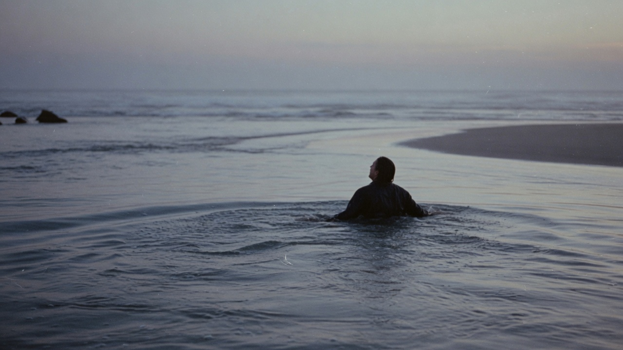 The River That Found Its Sea: a solitary figure wading peacefully into the wide twilight river current as it meets the sea